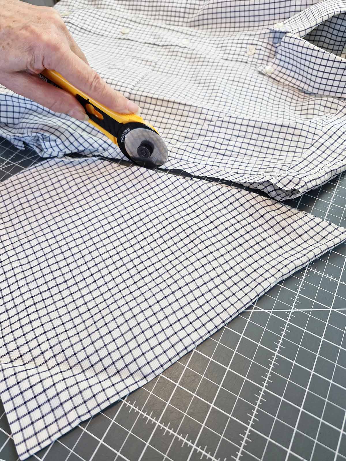 Cutting a shirt sleeve to prepare fabric for machine appliqué