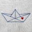 Paper boat with heart embroidery design stitched on cotton fabric