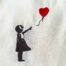 girl reaching for a heart-shaped balloon embroidery design