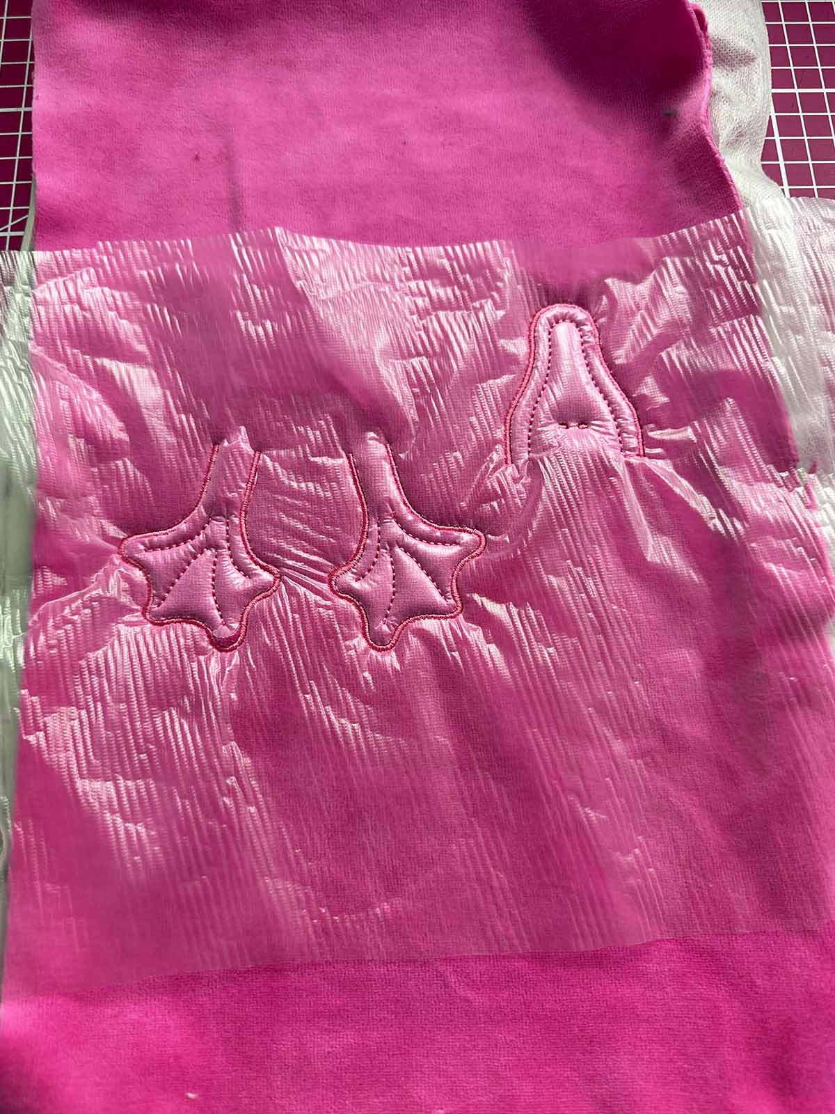 Completed beak and feet embroidery with water-soluble topping to prevent stitches from sinking into plush