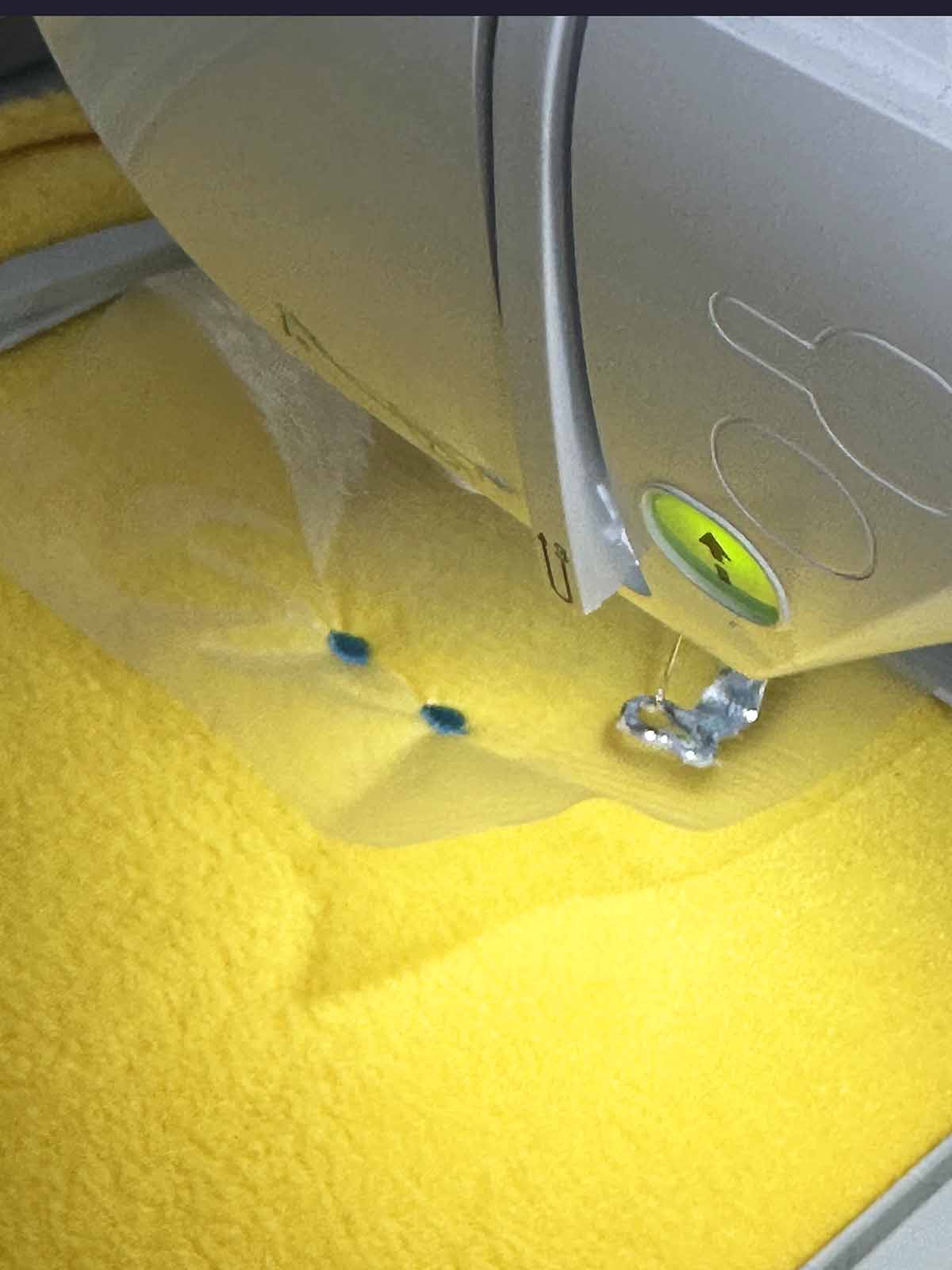 Duck eyes stitched on plush fabric with water-soluble topping to keep stitches clean and visible