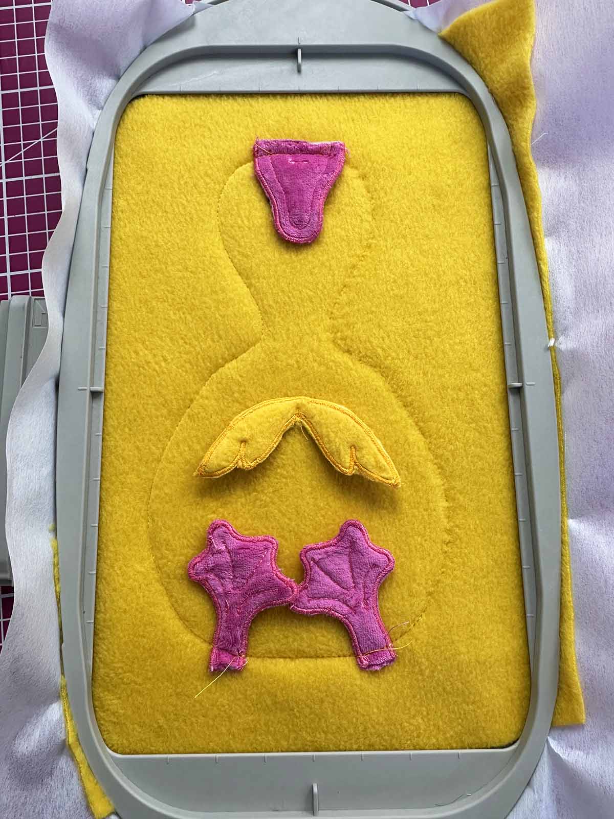 Wings, beak and feet positioned and stitched onto duck body using center-out stitching method