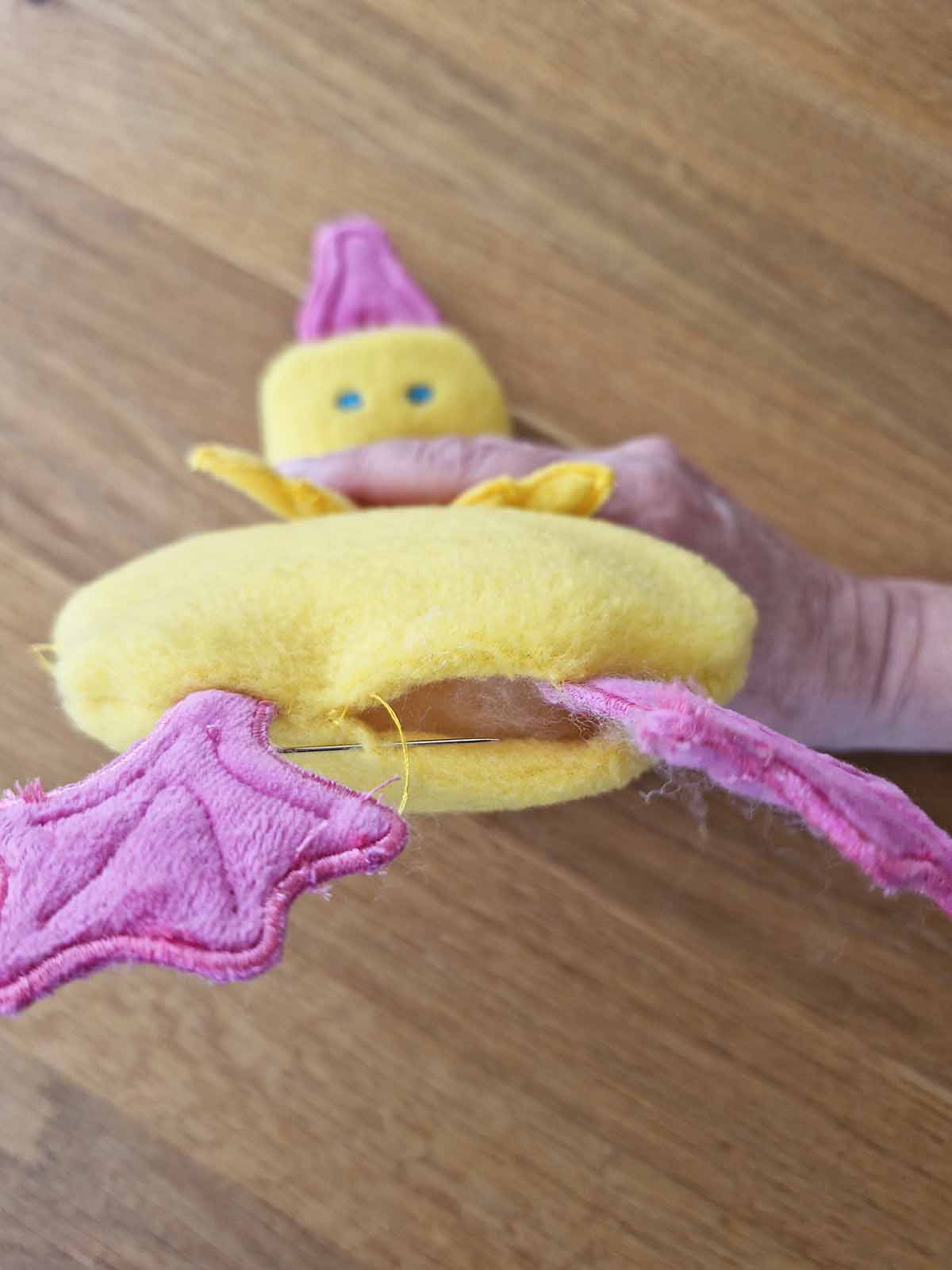 Turning opening of plush duck closed by hand using ladder stitch