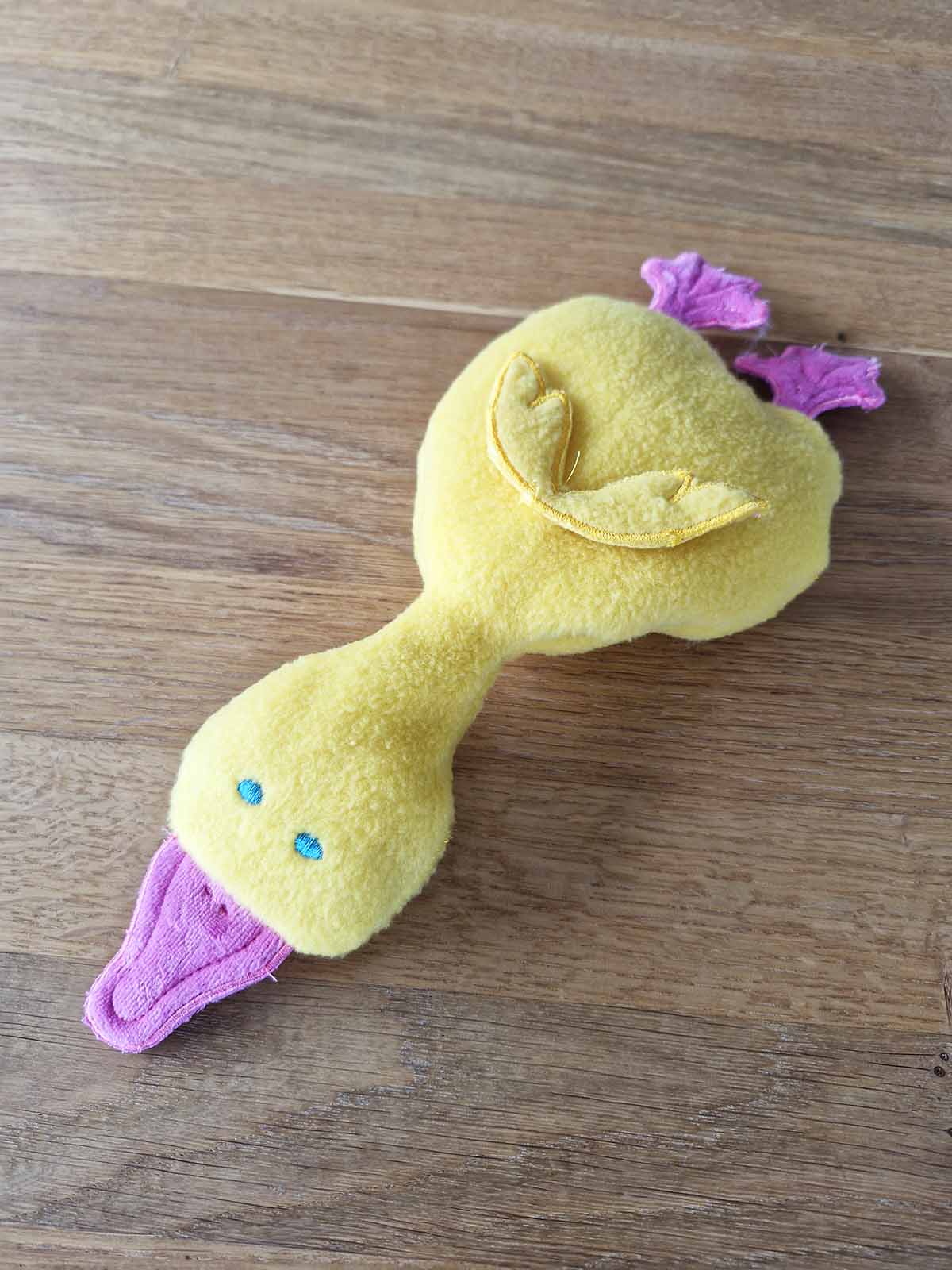 Finished plush duck toy fully assembled with wings, beak and feet attached