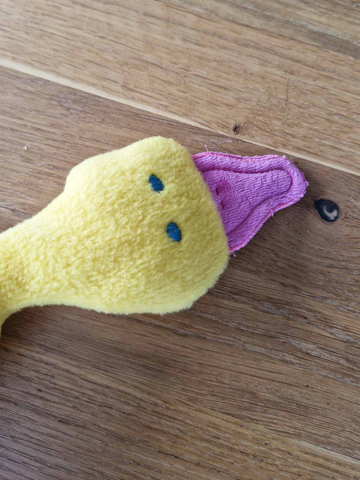 Close-up view of the finished plush duck head showing beak and stitched details