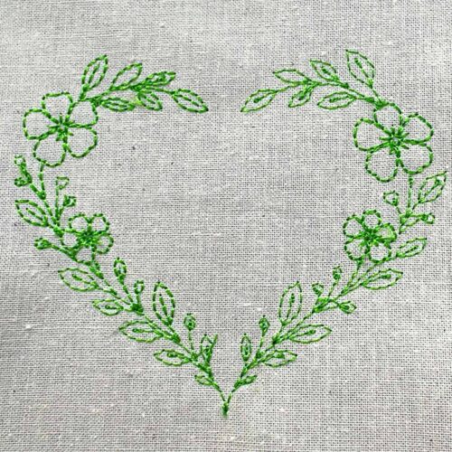 Floral heart wreath embroidery design made of flowers and leaves in a clean line style