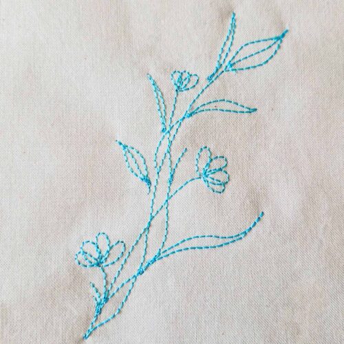 vintage floral vine embroidery design stitched on cotton fabric