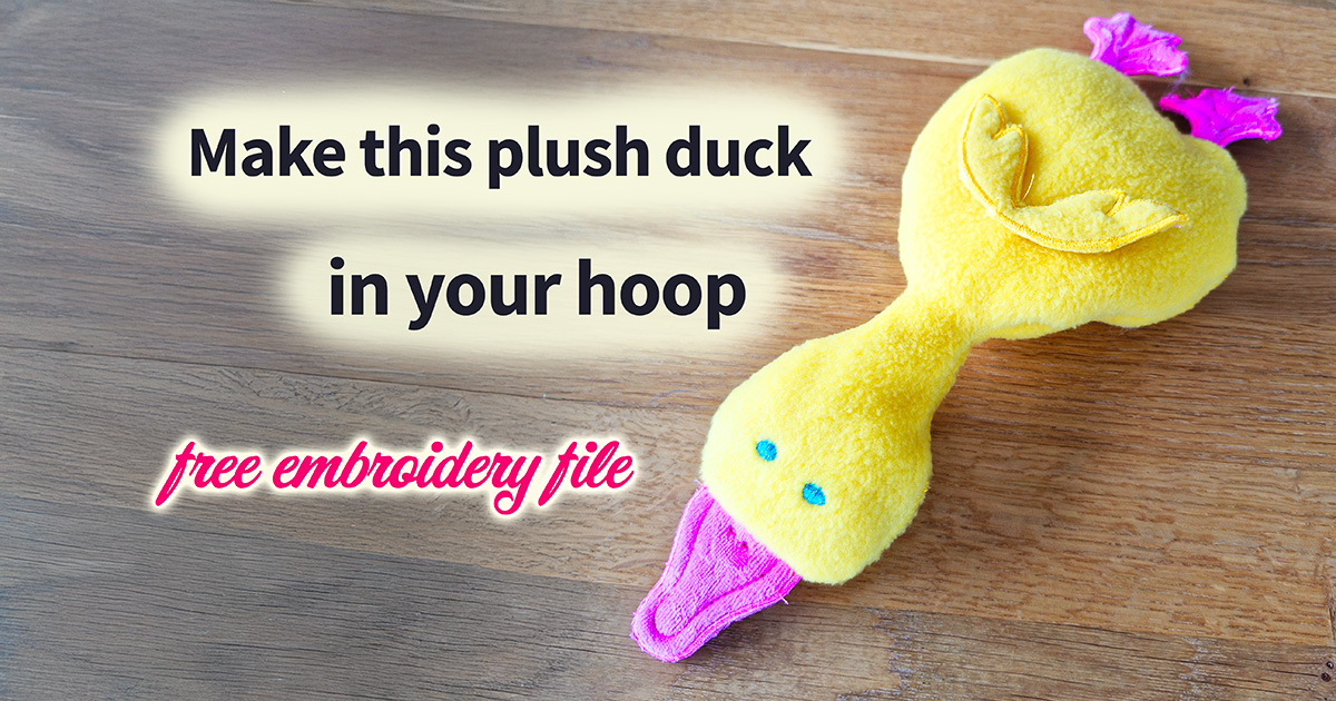 Finished ITH plush duck made with yellow plush fabric and pink beak and feet, soft toy created in the embroidery hoop