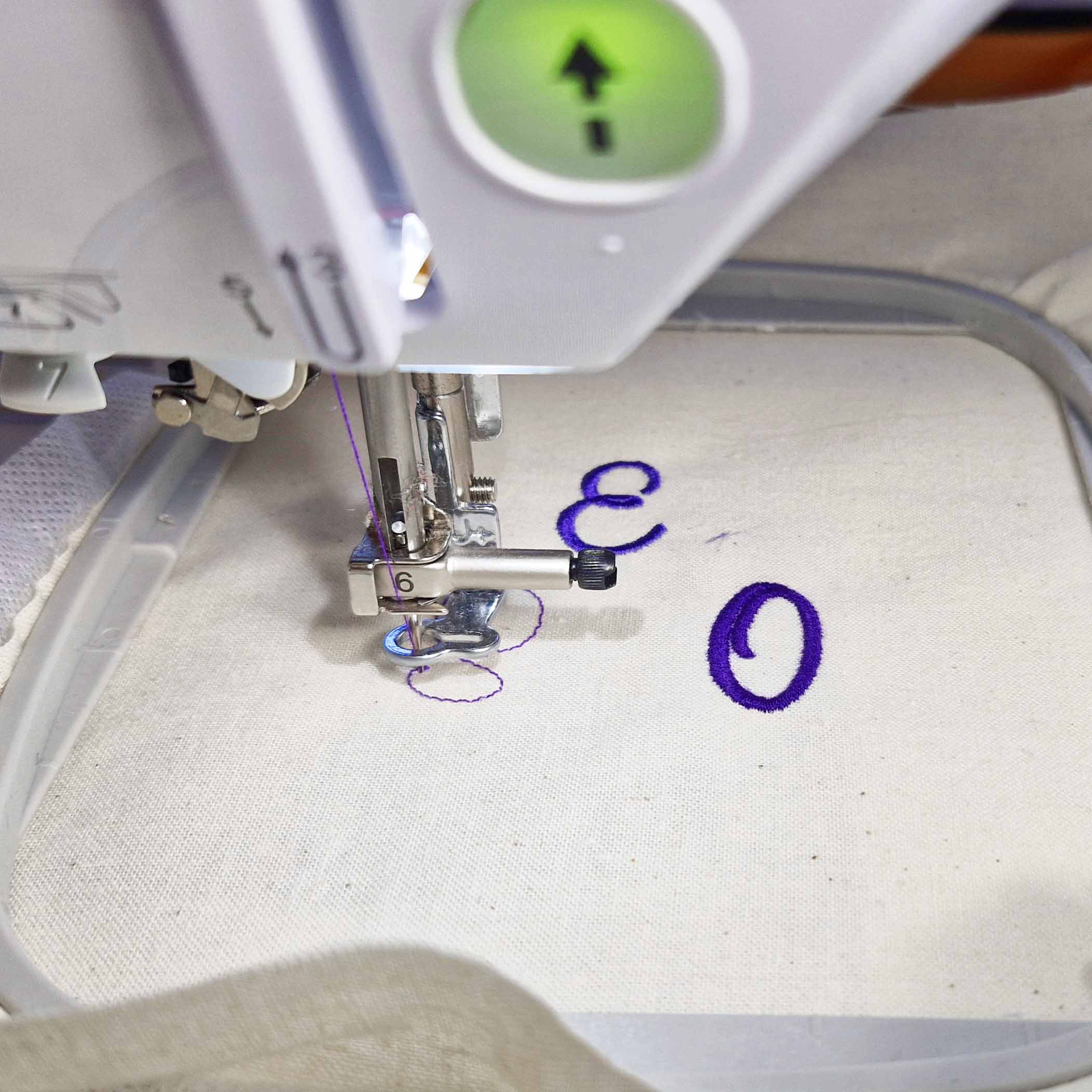 Close-up of a machine embroidery test using sewing thread to stitch a letter during the experiment