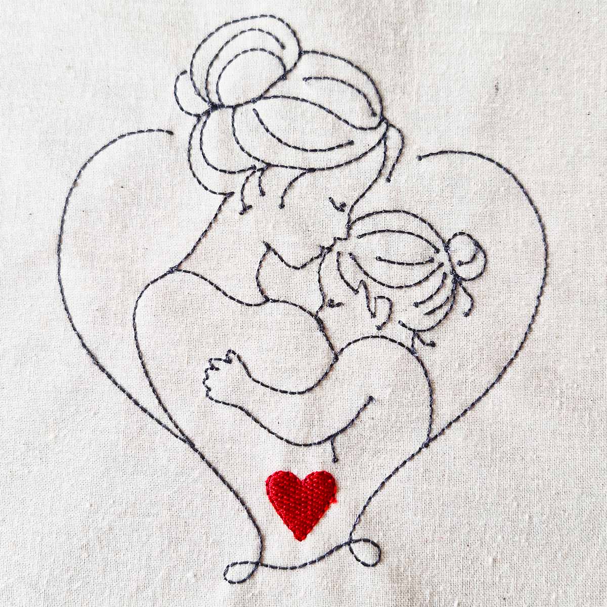 Mother and child line art embroidery design with heart detail stitched on cotton fabric