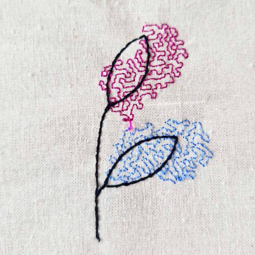 Minimal leaf line art embroidery design stitched on cotton fabric