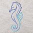 Seahorse satin line art embroidery design stitched in blue tones on cotton fabric.